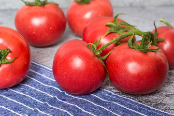 Cherry or cocktail tomatoes and carafe with olive oil on table.