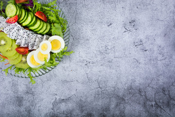 View from above of a wooden rustic table with several ingredients for cooking and filling arepas, typical Latin American food.