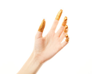 Hands in gold paint. Golden fingers. Female hand isolated on white background. White woman's hand showing symbols and gestures.
