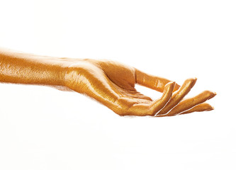Hands in gold paint. Golden fingers. Female hand isolated on white background. White woman's hand showing symbols and gestures.