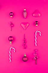 Colorful pink Christmas composition with decorations on vivid pink background