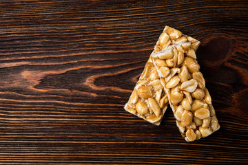  Peanut kozinaki on dark wooden background.