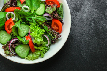 healthy salad (tomato, cucumber, mix leaves, onions and other ingredients) top menu concept. food background. copy space