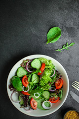 healthy salad (tomato, cucumber, mix leaves, onions and other ingredients) top menu concept. food background. copy space