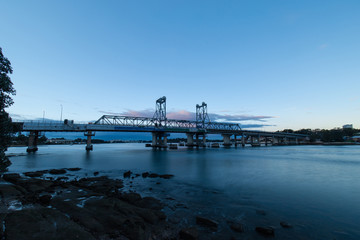 Parramatta River side view with Ryde Bridge at dawn.