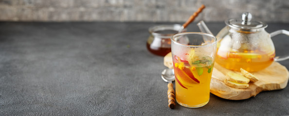 Tea set composition with hot tea on dark grey background