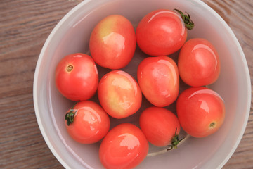 Red tomatoes in water, fresh fruits top view background.