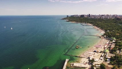 Hyperlapse aerial shot of sea coast line during summer sunny day, boats are passing by