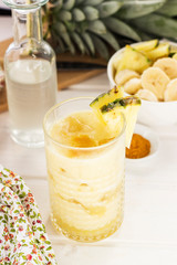 Pinapple and banana smoothie served in a glass