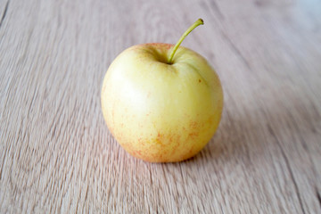 close up red apple isolated on wood background