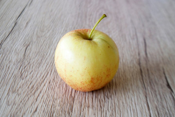 close up red apple isolated on wood background
