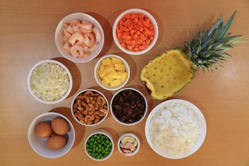 Ingredient for cooking Pineapple fried rice recipe serve in fresh pineapple bowl.