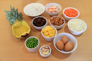 Ingredient for cooking Pineapple fried rice recipe serve in fresh pineapple bowl.