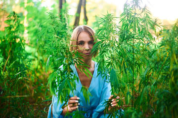 woman in a bush of wild hemp in nature