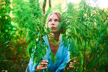 woman in a bush of wild hemp in nature