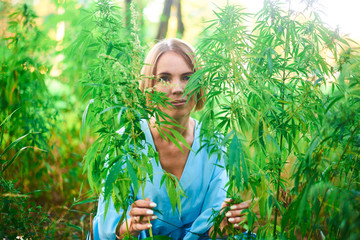 woman in a bush of wild hemp in nature