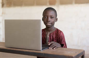 Little African Business Boy Studying in his School Desk