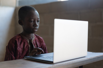 Technology for Future Africa, Black Boy Learning with Laptop