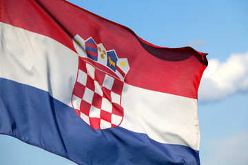Flag of Croatia blowing in the wind. Bright blue sky in the background.