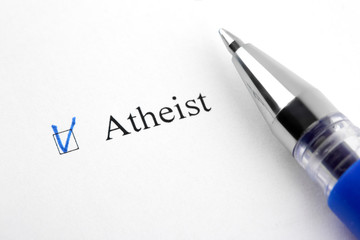Fototapeta premium Atheist. Filling in the questionnaire, documents. The checkboxes are filled with a black pen on a white background. Questionnaire, survey.