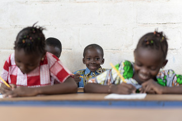 Classroom Full of African Students Smiling and Working in School