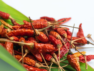 dried bird's eye chillies on green leaf