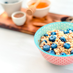 High protein healthy breakfast, buckwheat porridge with blueberries, flax seeds and honey