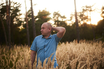 a man in the field in the grass at sunset