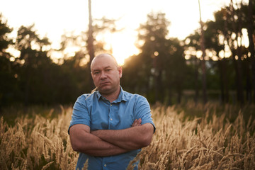 a man in the field in the grass at sunset