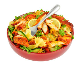 Chicken tikka and pasta salad bowl isolated on a white background