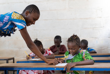 Woman Teacher in School with her African Children Girls Pupils