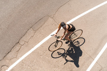 Young attractive fit girl riding a bicycle