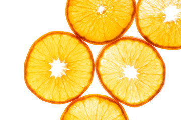 Macro photo of slices of juicy orange with back light isolated on white background. Top view