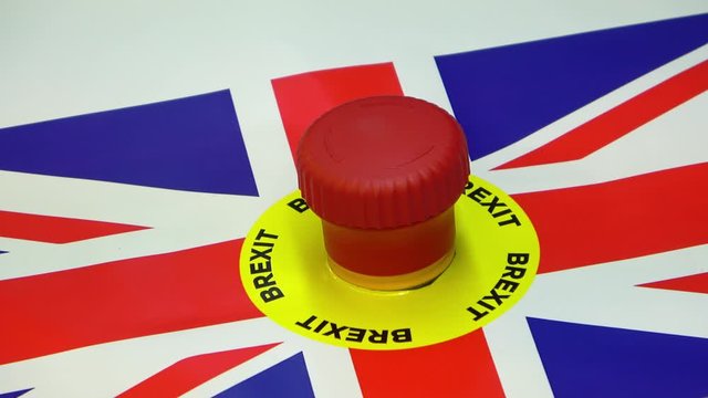 Hand pushing panic button with brexit text and Britain flag. Conceptual Britain exit of European Union footage