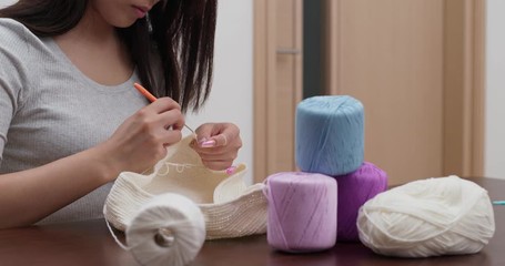 Woman knitter making fabric from thread