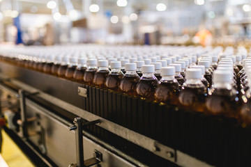 Bottling factory - Apple juice bottling line for processing and bottling juice into bottles. Selective focus.