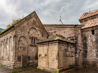 Fototapeta na wymiar Ancient walls and grassy roofs of 12th- or 13th-century Armenian monastic complex of Goshavank on a rainy summer day.