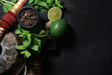 bowl with tobacco for hookah. fruits on a black background