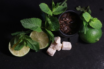 bowl with tobacco for hookah. fruits on a black background