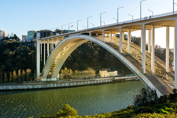 Arrabida Bridge against the sunset on the Duoro river, Porto, Portugal