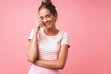 Image of pretty beautiful woman wearing striped clothes smiling and rejoicing at camera