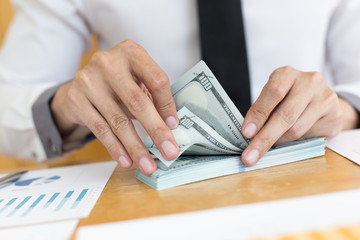 Fototapeta premium Toned picture,Men using hands to count dollar bills