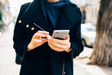 Close-up of female's hands holding mobile phone