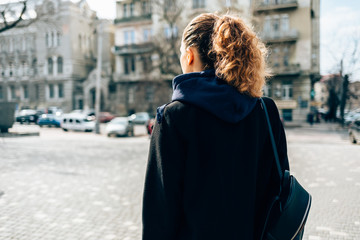 Female with curly hair and ponytail hairstyle