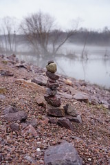 Stacked stones by someone during a foggy afternoon