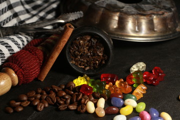 bowl with tobacco for hookah. berries on a black background