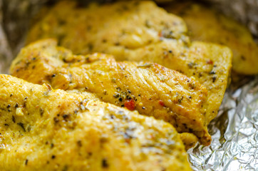 Chicken breasts baked with seasoning in foil