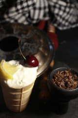 bowl with tobacco for hookah. fruits on a black background