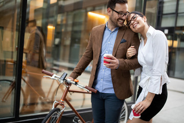 Office woman with business man couple enjoying break while talking flirting outdoor