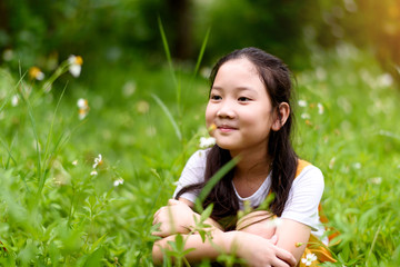 Young girl sit on a flower field